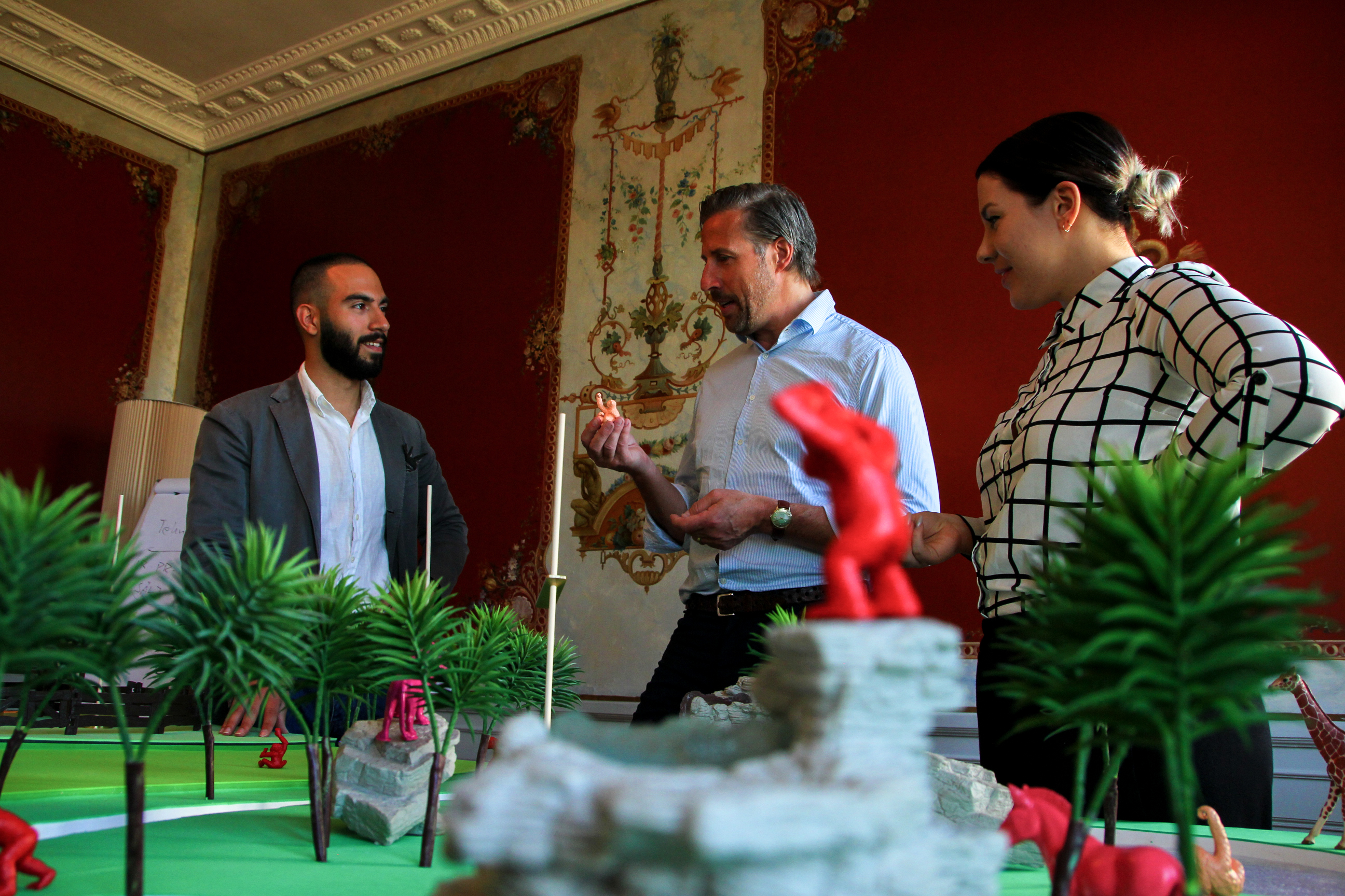 Team discussion reviewing outcomes and impact in an indoor space